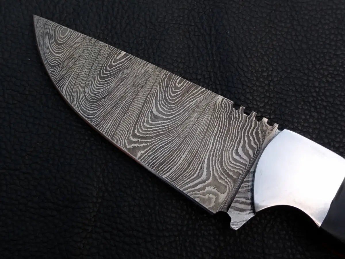 Handmade Damascus Steel Skinning Knife-C25 on black surface