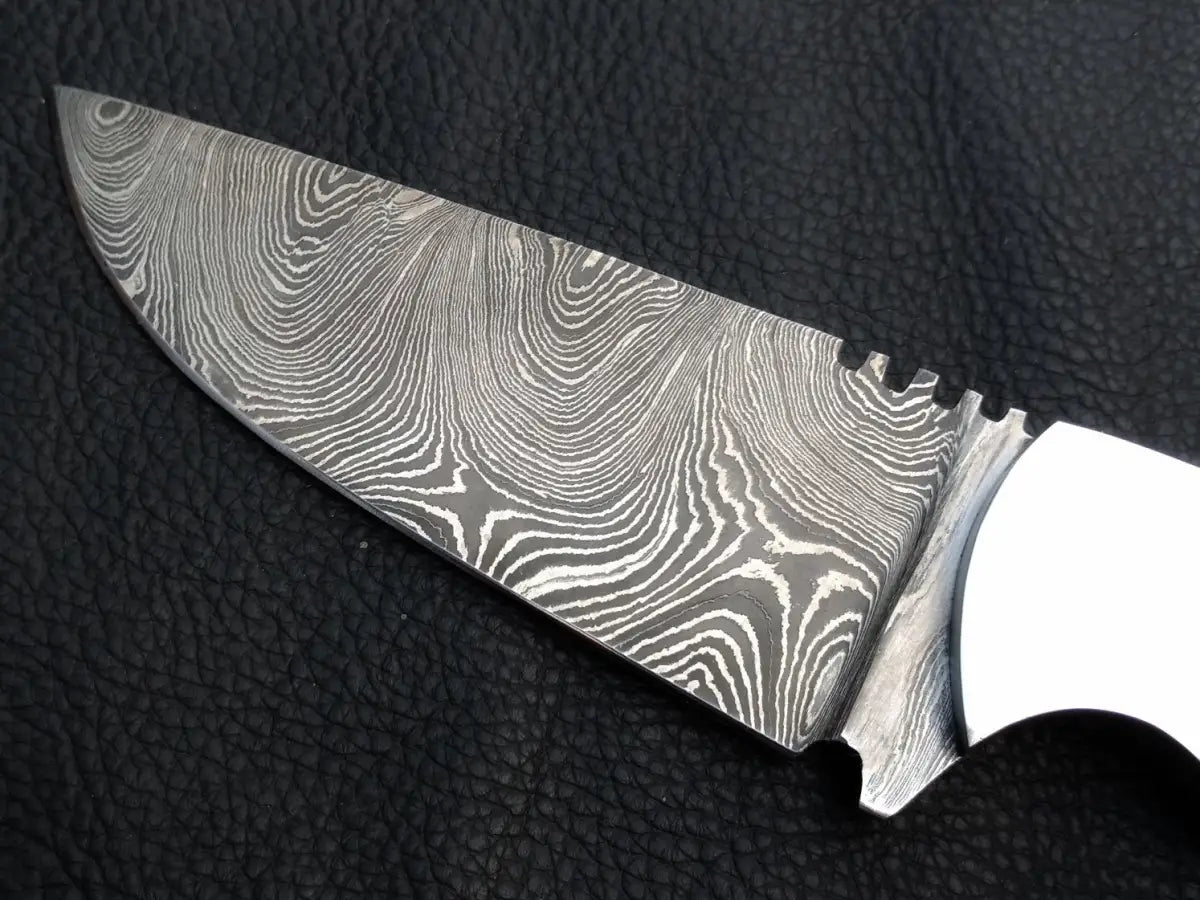 Handmade Damascus Steel Skinning Knife-C26 on black surface.