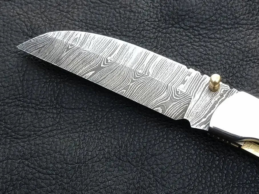 Handmade Damascus Steel Folding Knife - C165 showcasing intricate blade design and durability