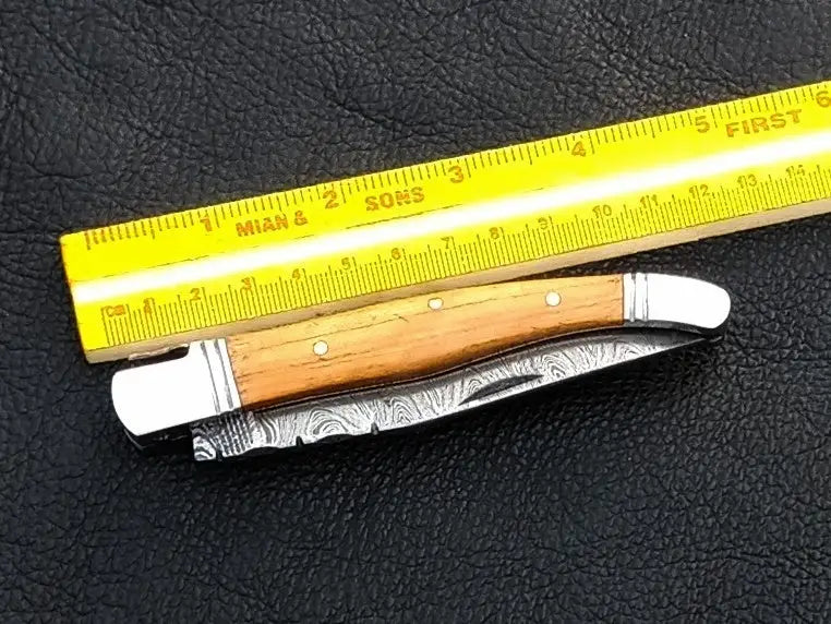 Handmade Damascus Steel Folding Knife C161 showcasing unique patterns and craftsmanship