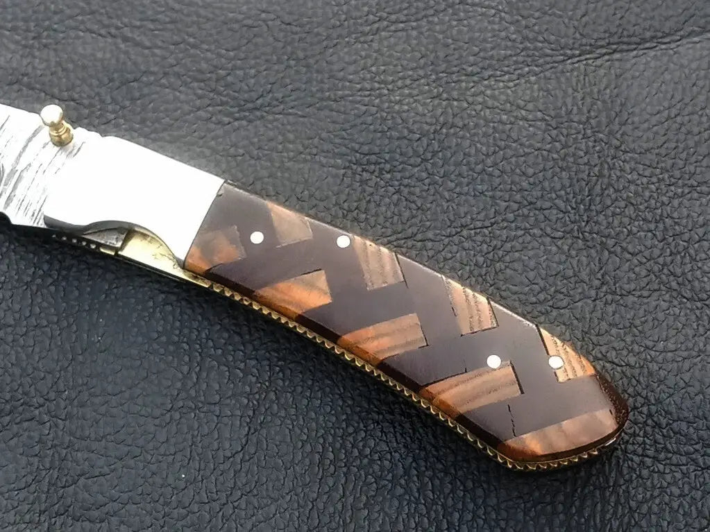 Handmade Damascus Steel Folding Knife with a beautifully patterned handle design