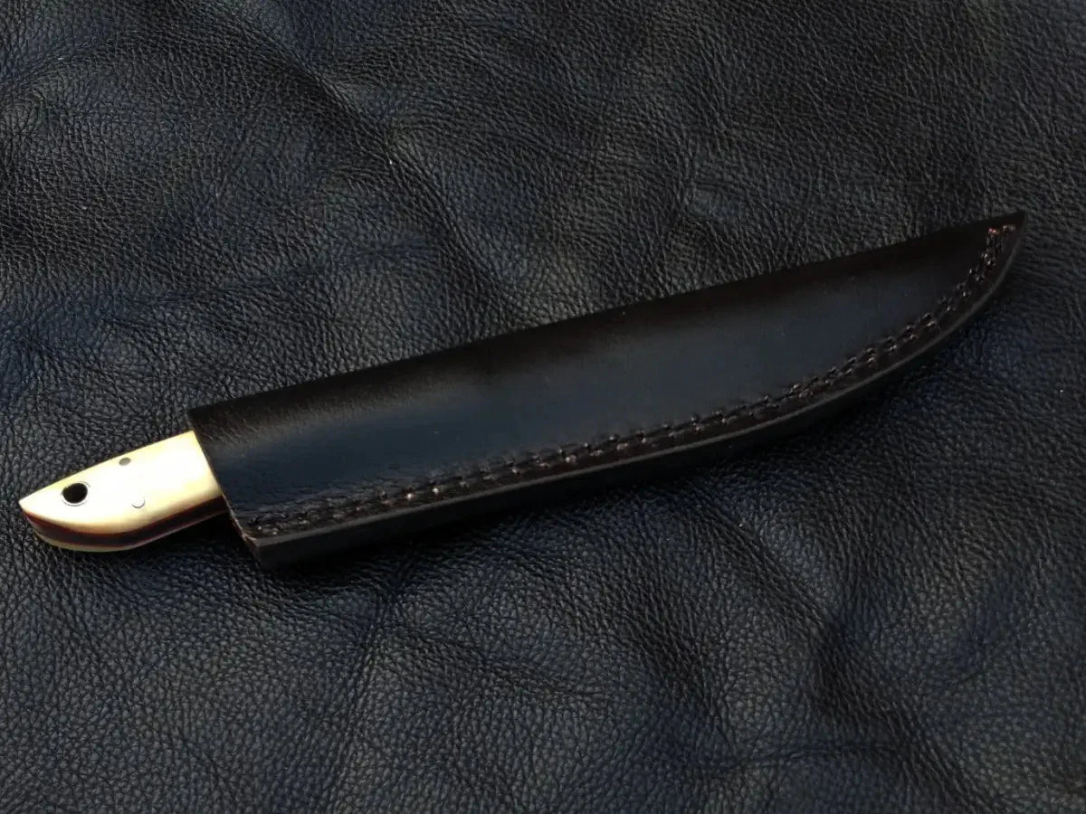 Damascus Steel Bird and Trout Knife on Black Leather Surface