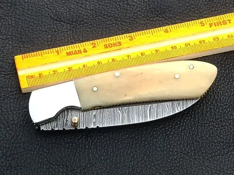 Handmade Damascus Steel Folding Knife with bone handle for outdoor enthusiasts