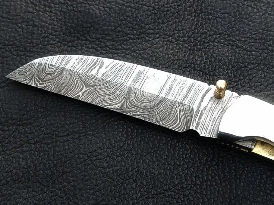Handmade Damascus Steel Folding Knife C167 showcasing intricate patterns and craftsmanship