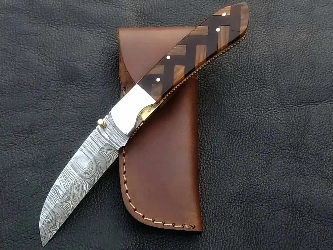 Handmade Damascus Steel Folding Knife C167 with leather sheath, showcasing intricate design