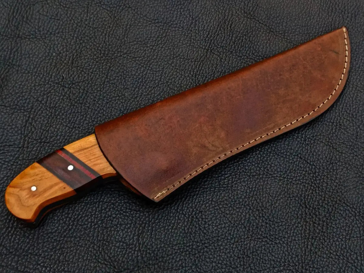Handmade Damascus Steel Hunting Knife in a leather sheath for outdoor enthusiasts