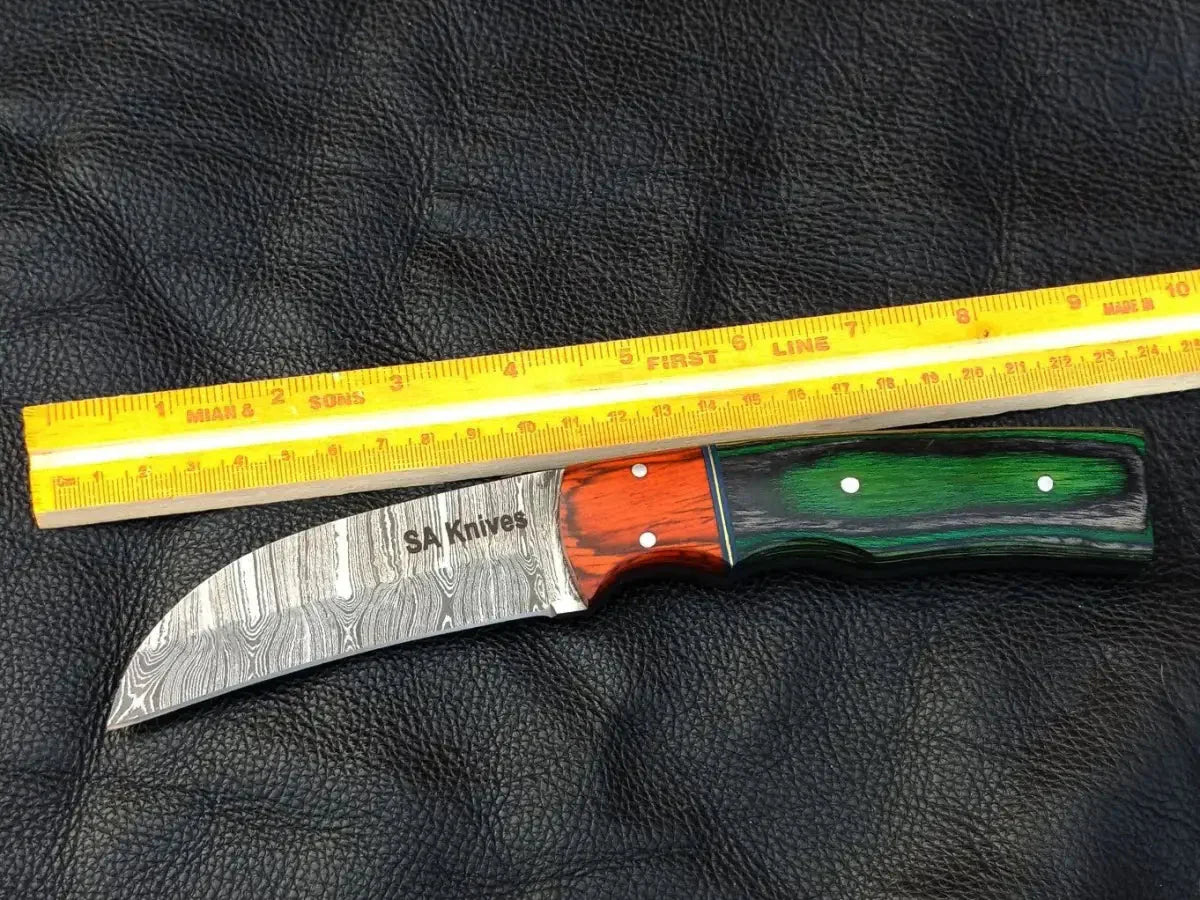 Damascus steel bolster skinning knife with green grey handle and orange bolster