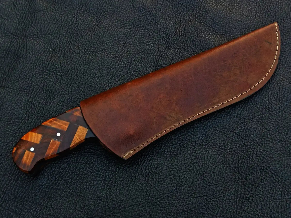 Handmade Damascus Steel Hunting Knife with patterned handle in sheath