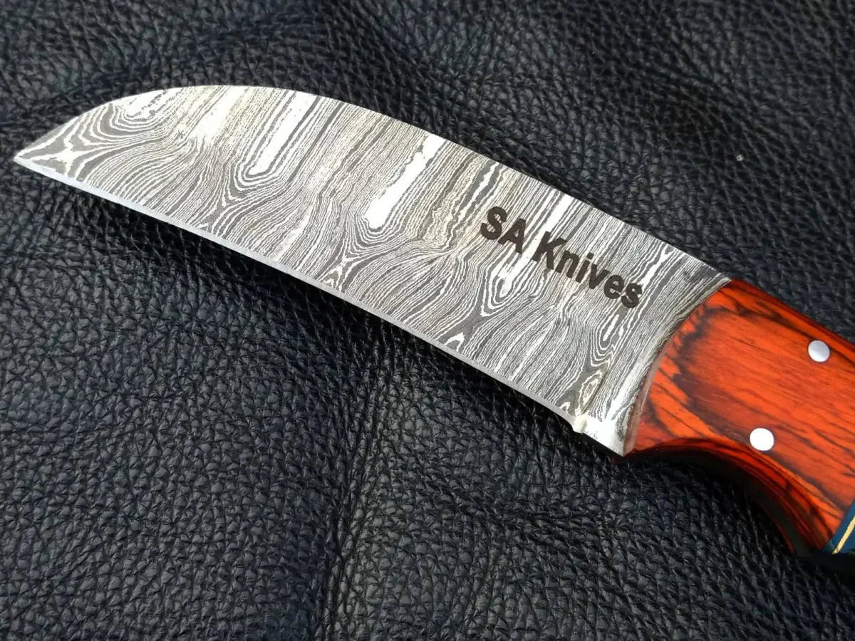 Damascus steel bolster skinning knife with green grey handle and orange bolster design