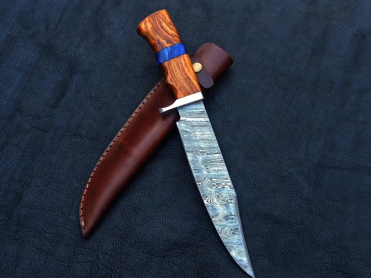 Handmade Damascus Steel Bowie C145 with wooden handle and leather sheath displayed