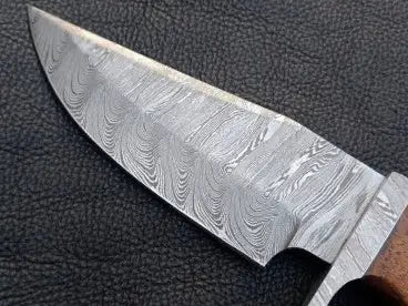 Handmade Damascus Steel Hunting Knife blade displaying unique patterns and craftsmanship