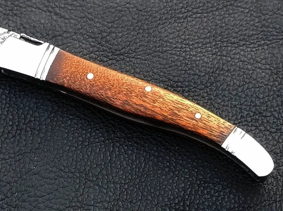 Handmade Damascus Steel Folding Knife with Wooden Handle on Leather Surface -C163
