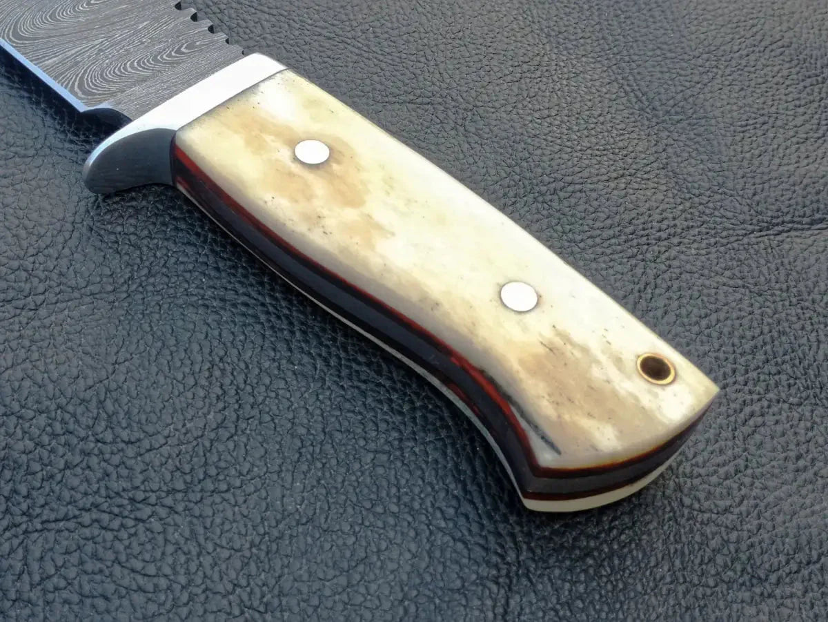Handmade Damascus Steel Hunting Knife on Black Leather Surface
