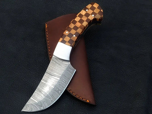 Handmade Damascus steel knife with wooden handle on black background
